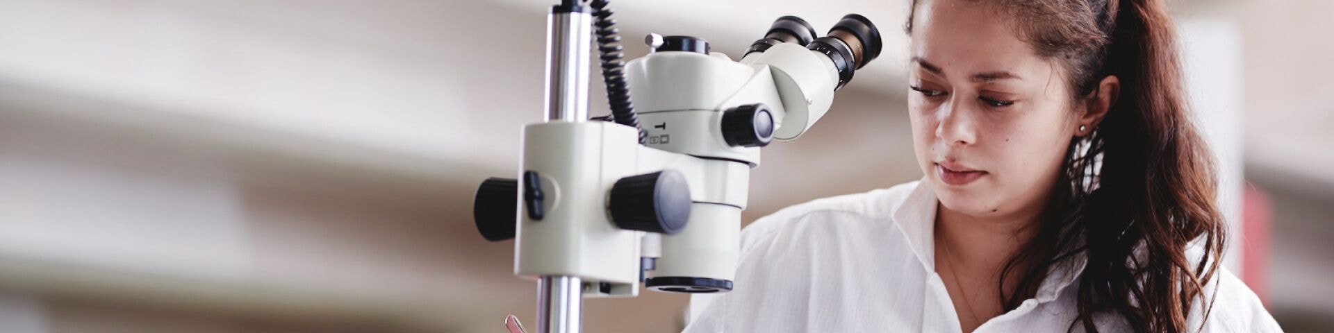 Woman working with a microscope