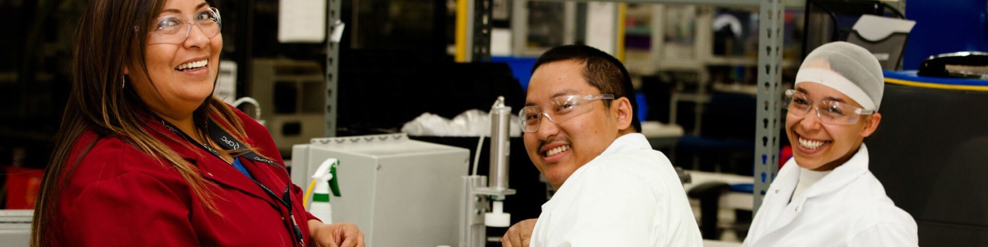 Workers smiling at camera in lab facility
