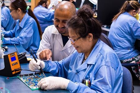 Woman working on circuit board