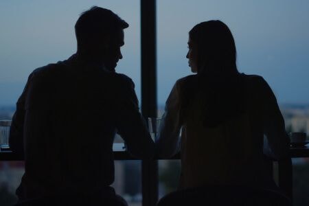 Two people talking in silhouette