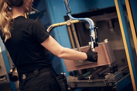 Woman working a machine in factory