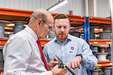 Two men examining a hardware piece