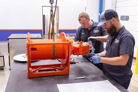 Two men working on a winch
