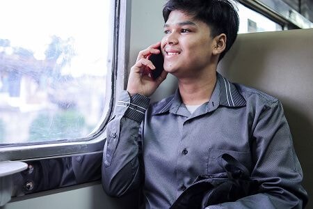 Man talking on phone on train