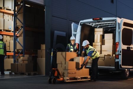 Workers unloading truck in a warehouse
